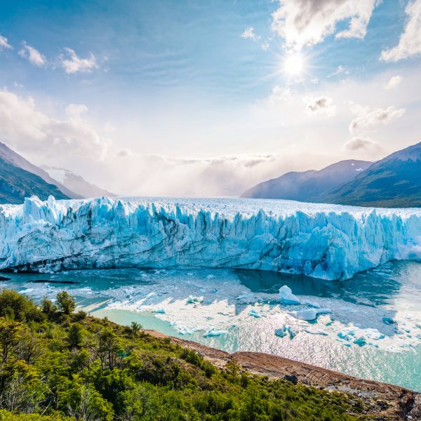 Ice collapsing into the water at Perito Moreno Glacier in Los Glaciares National Park near El Calafate, Patagonia Argentina, South America.